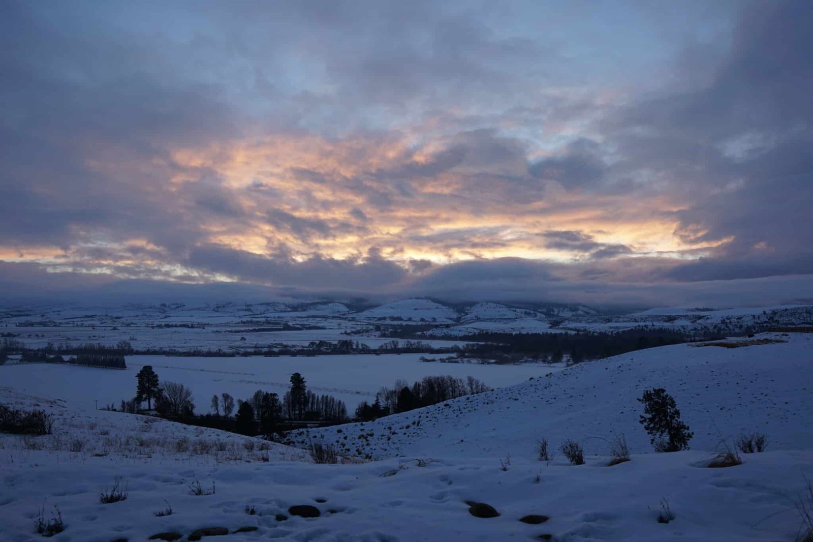 Snowy landscape under a colorful sky