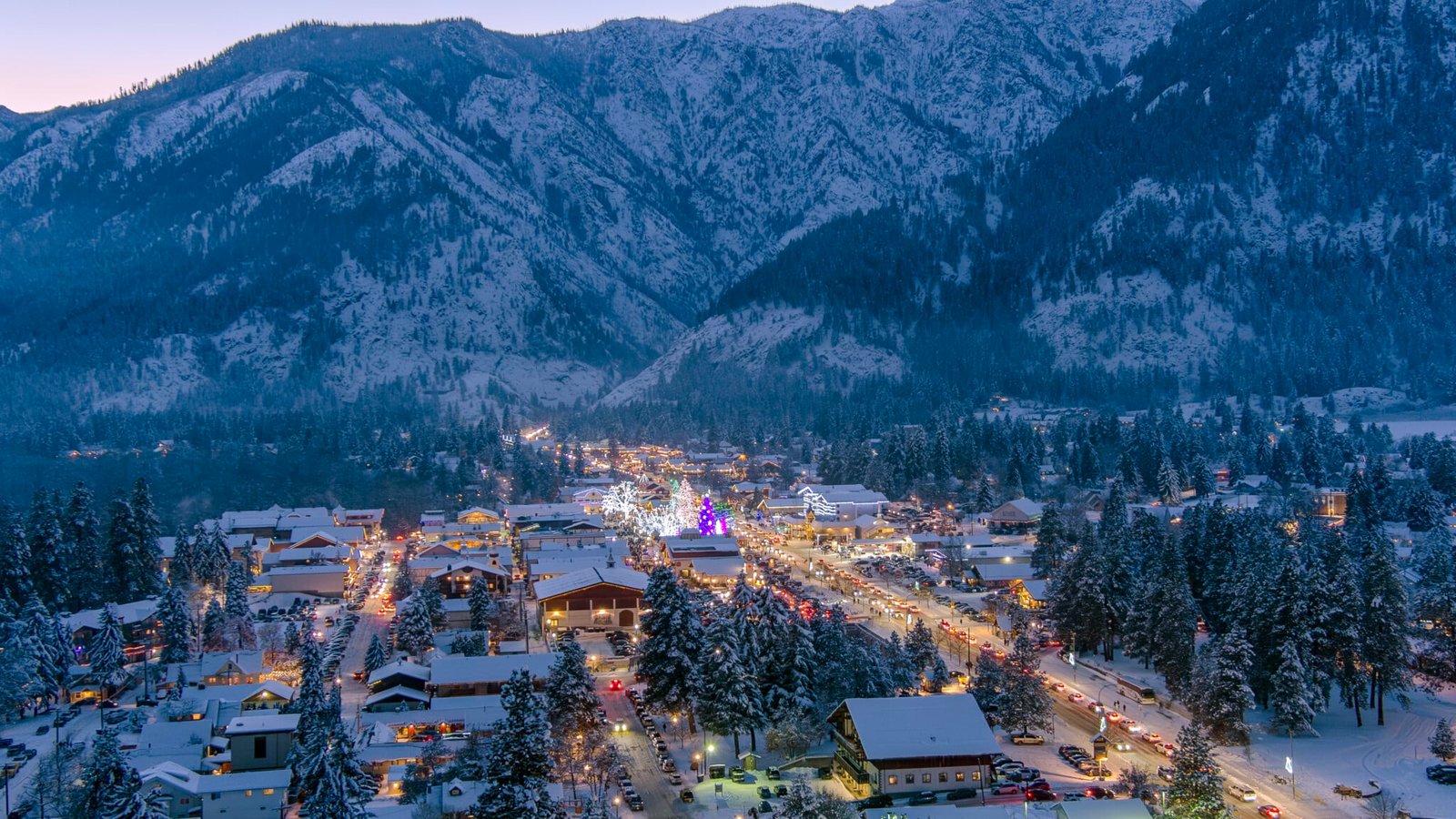 Snowy town illuminated at dusk