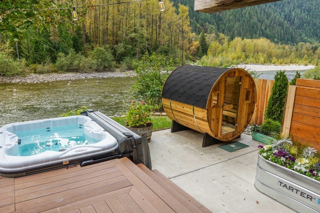 Cabin rental near Stevens Pass — The Gateway in Gold Bar WA, with barrel sauna and hot tub above the Skykomish River in spring.